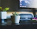A sleek modern desk adorned with a small succulent in a minimalist white planter.
