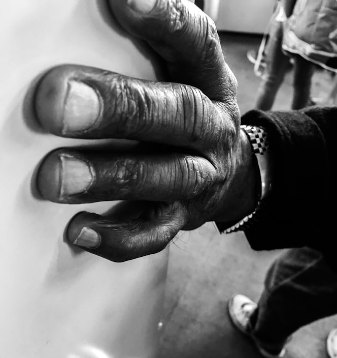 Close-up of rugged tactical gloves gripping a metal surface in low light