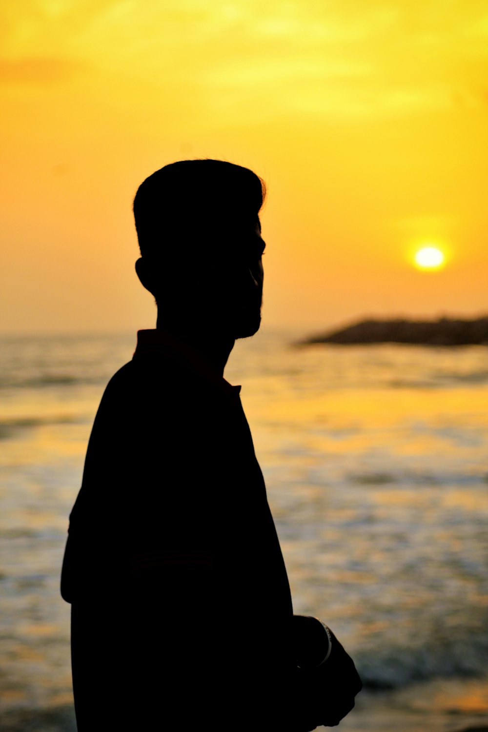 silhouette man standing near sea