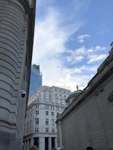 Wide shot of a city skyline with multiple security cameras visible on buildings.