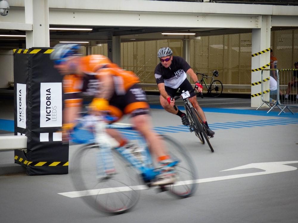 two men riding bicycle