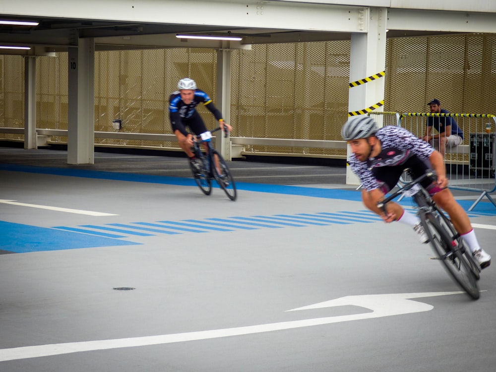 two men riding on bicycle