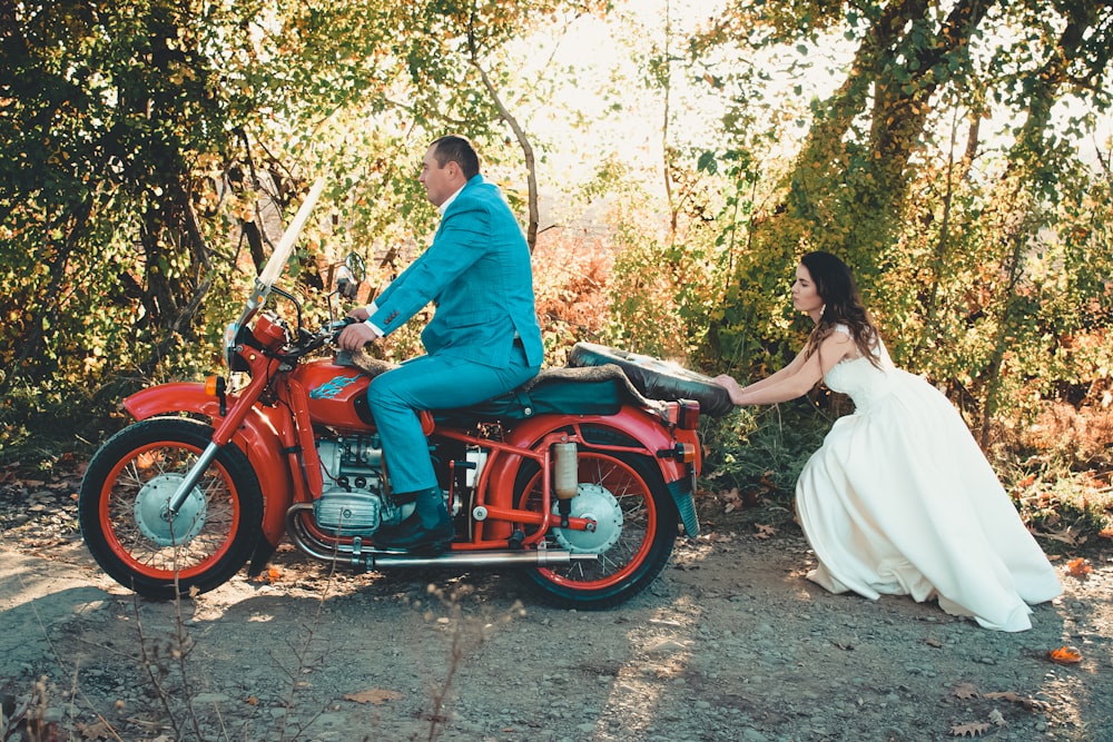 bride pushing groom in motorcycle