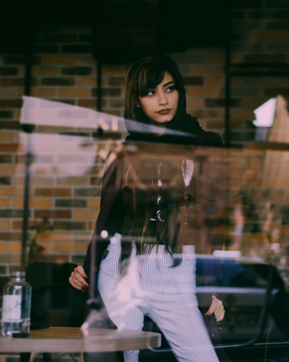 woman in black long-sleeved shirt and white pants