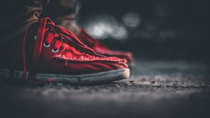 A close-up of a youngka sneaker scuffed from city pavement, showing raw texture and grit.