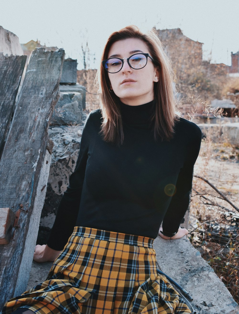 woman sitting on gray concrete surface