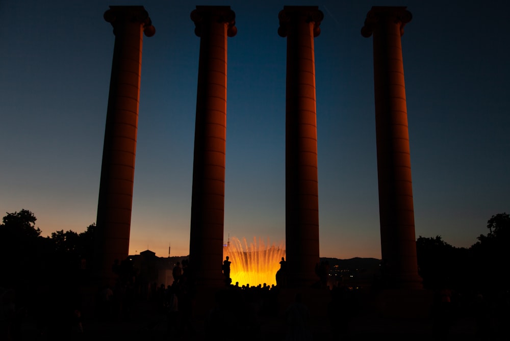 four beige concrete pillars