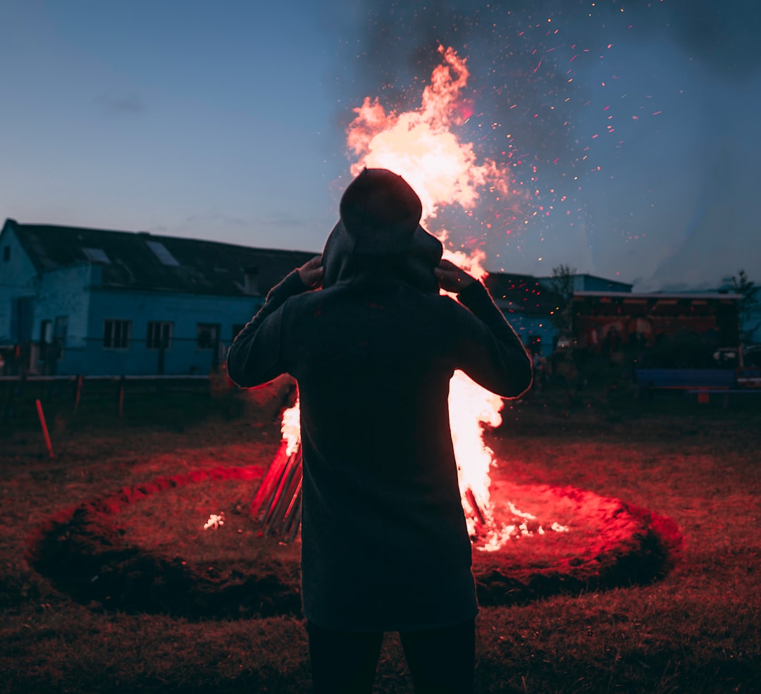person standing in front of bonfire