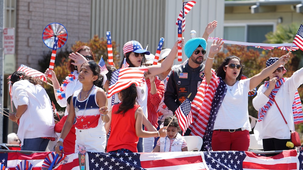 people holding an America flag during daytime