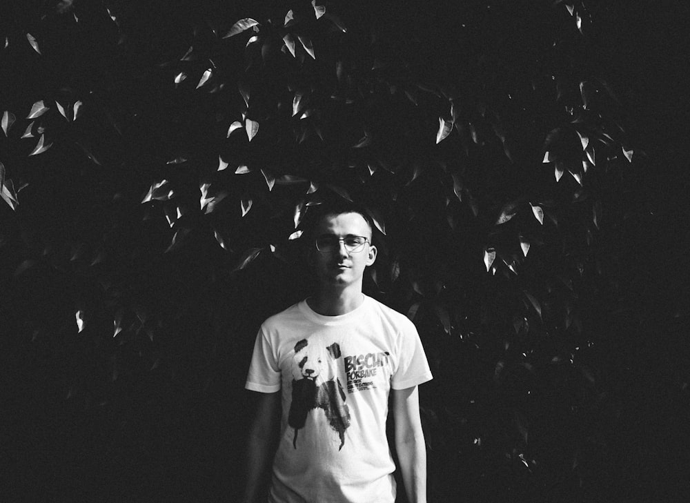 grayscale photo of man in white crew-neck T-shirt