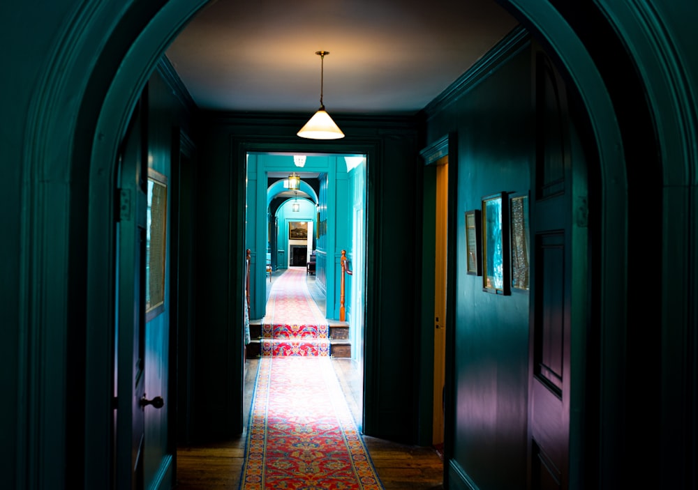 a hallway with a red carpet and blue walls