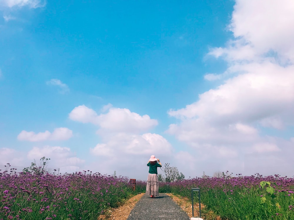 person standing near flower field