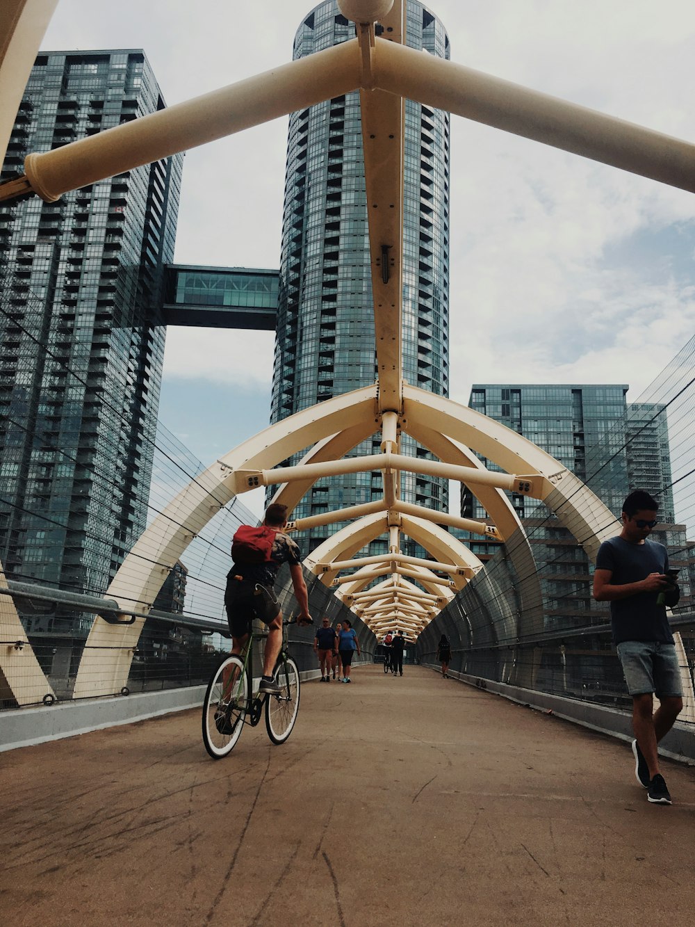 man riding bicycle under white clouds