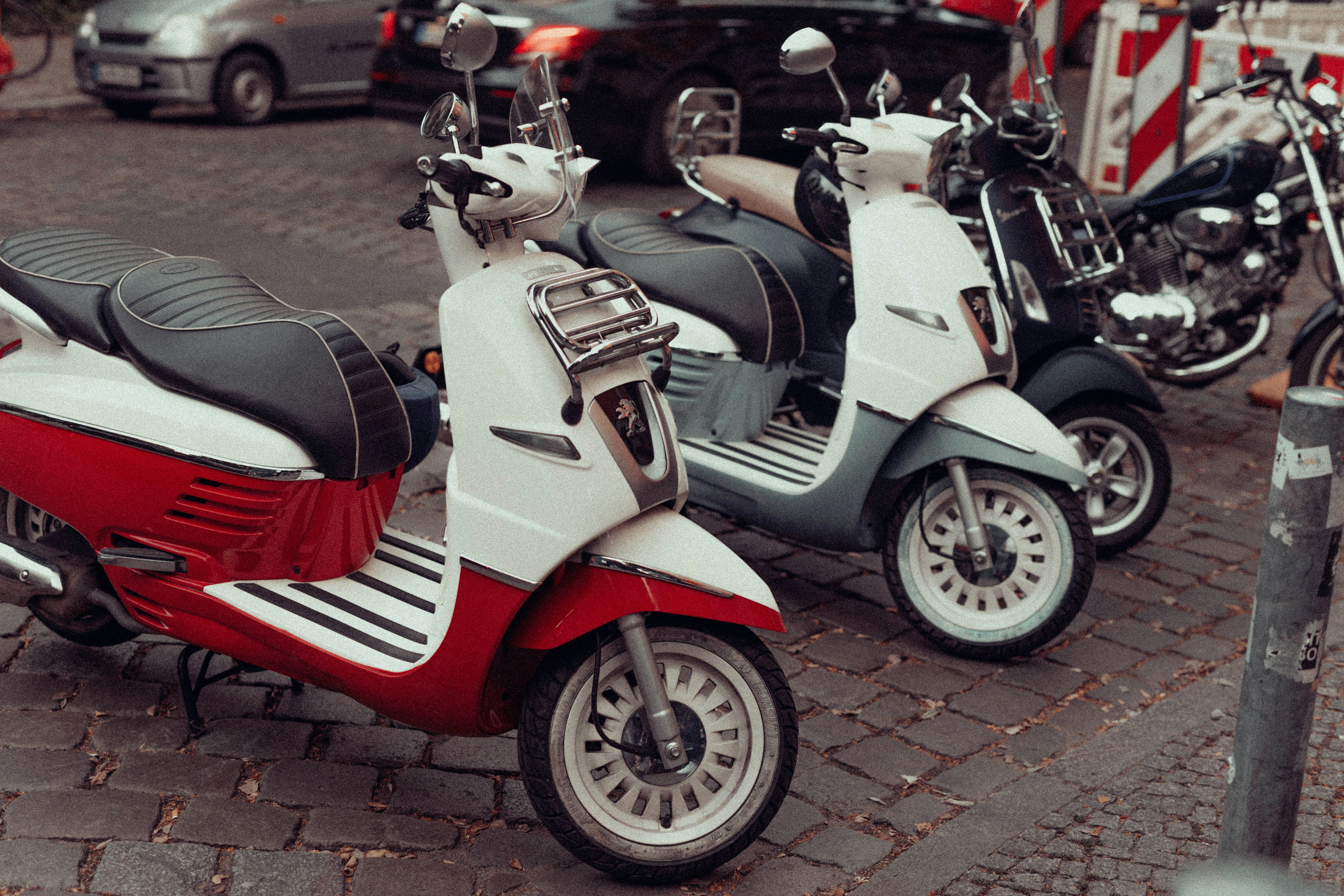 shallow focus photo of motor scooters parked