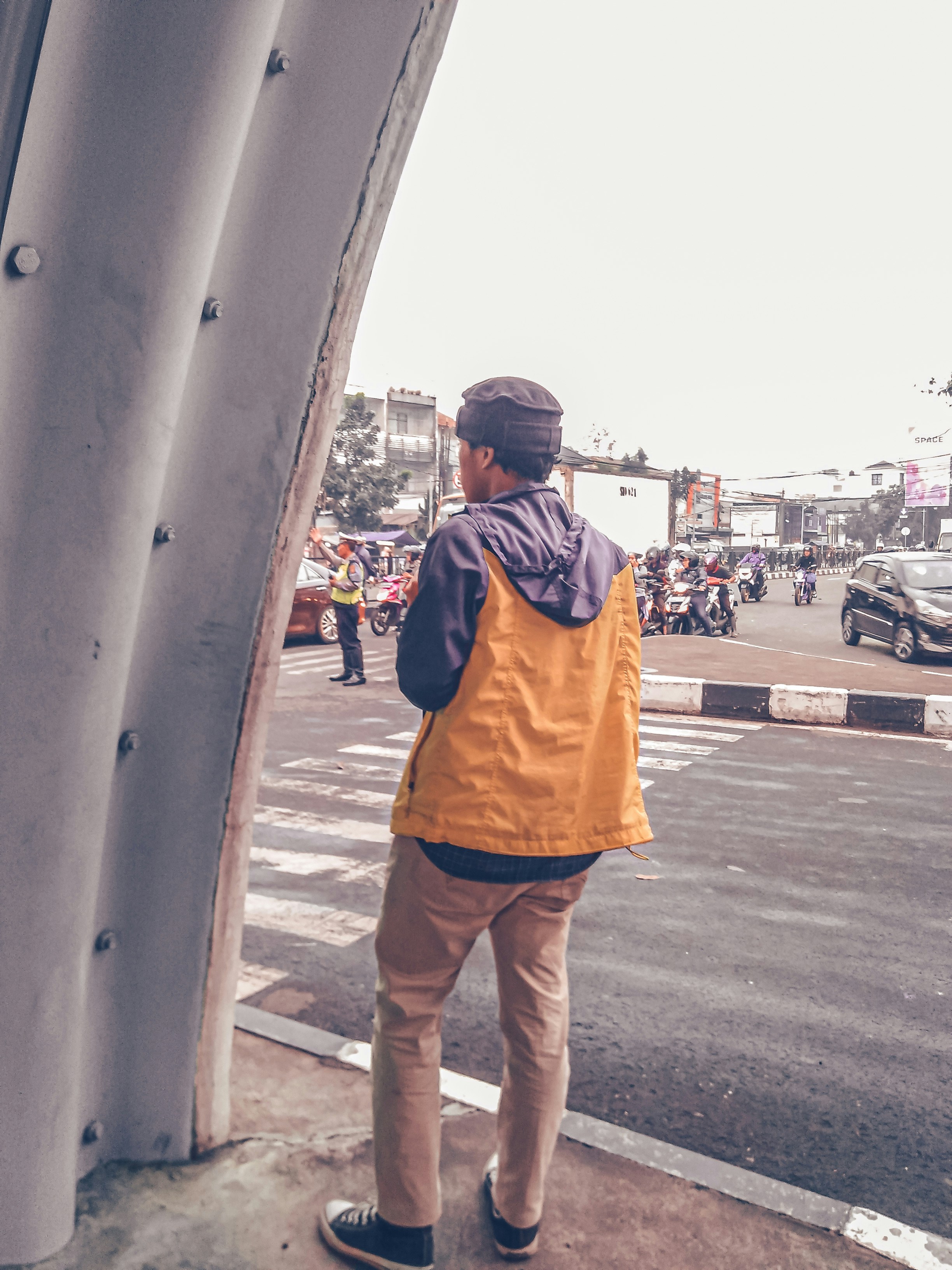 man in black and yellow hoodie