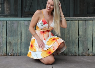 woman sitting beside wall