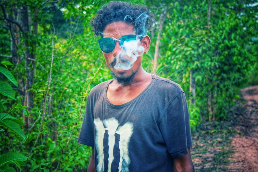 man in black crew-neck T-shirt smoking