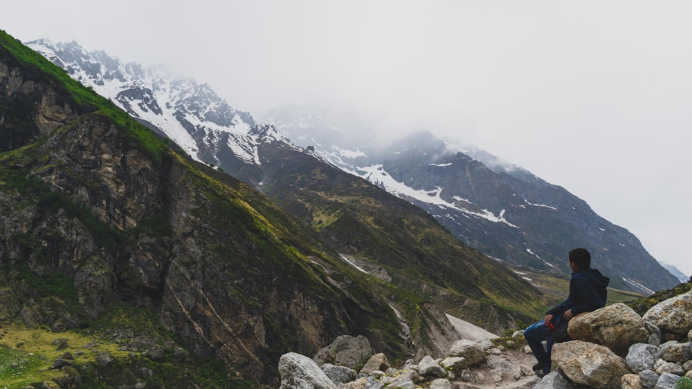 person sitting on rock