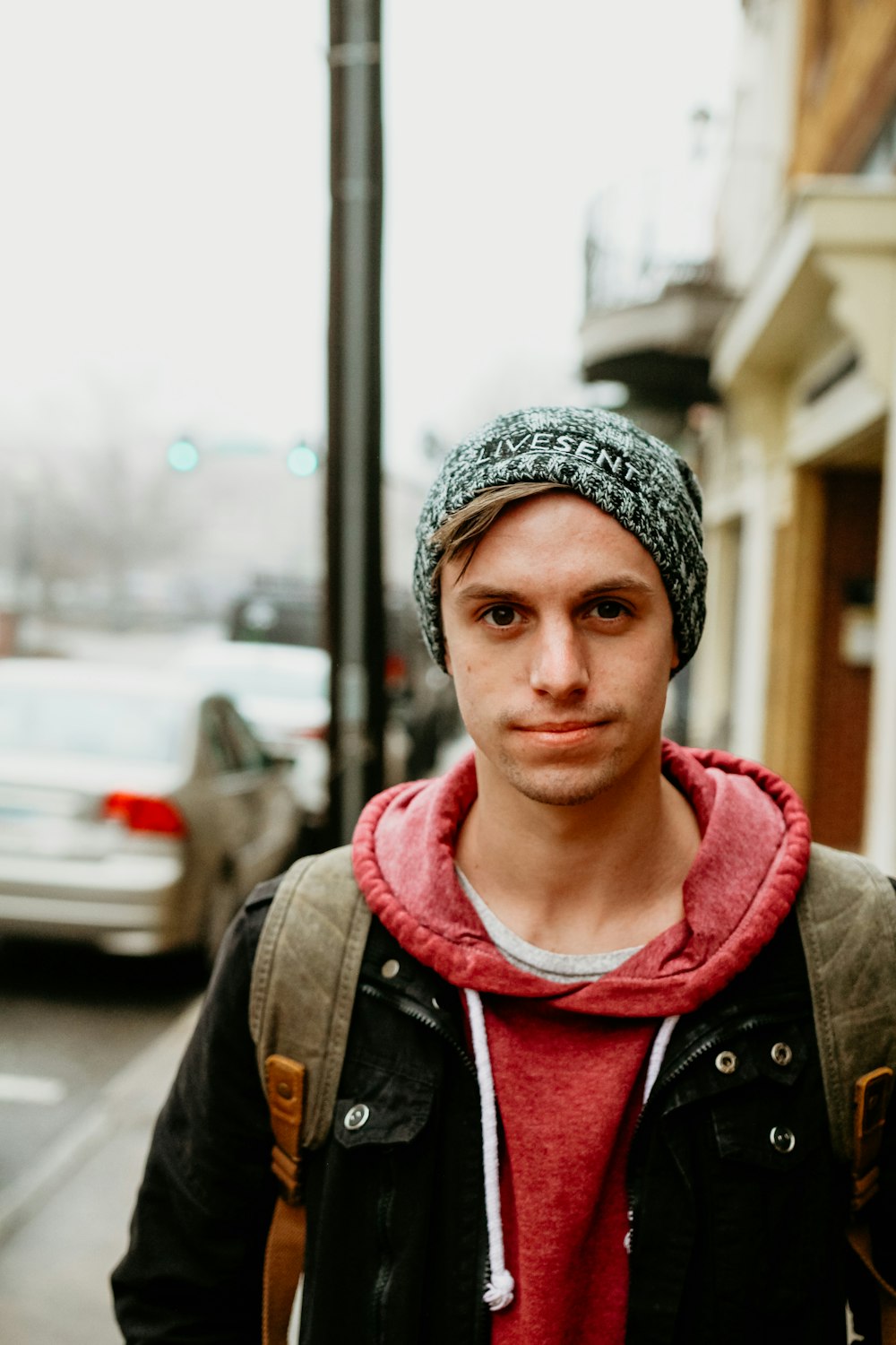 shallow focus photo of man in red hoodie