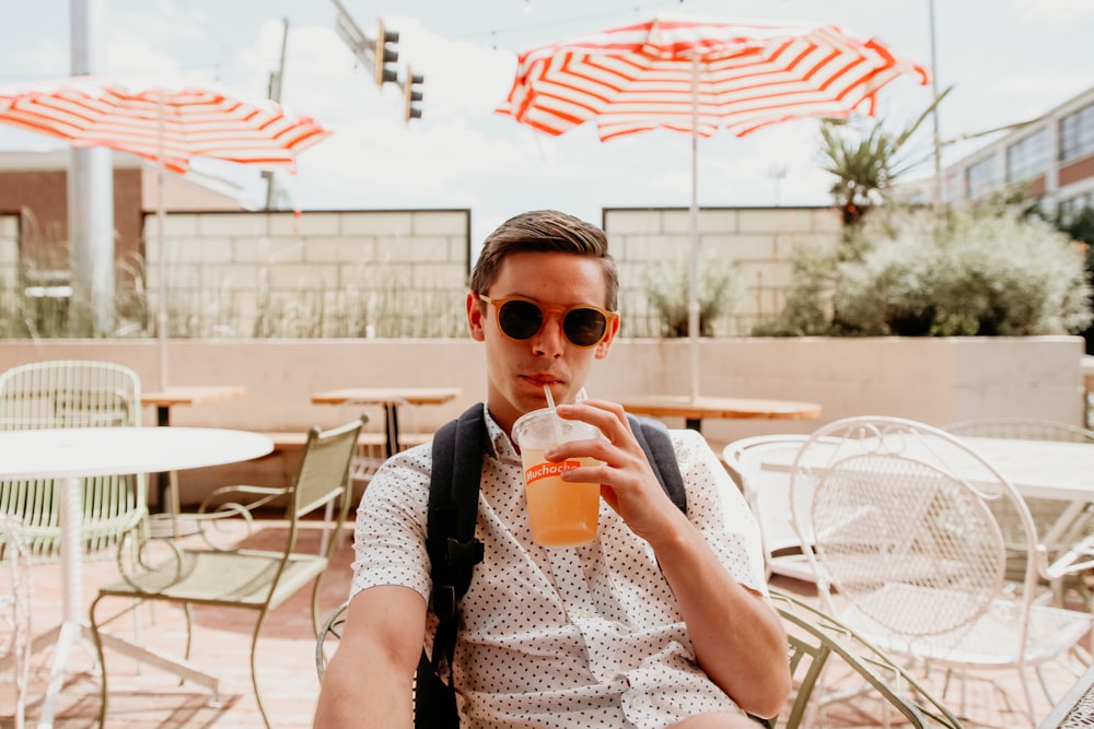 man sipping on plastic bottle