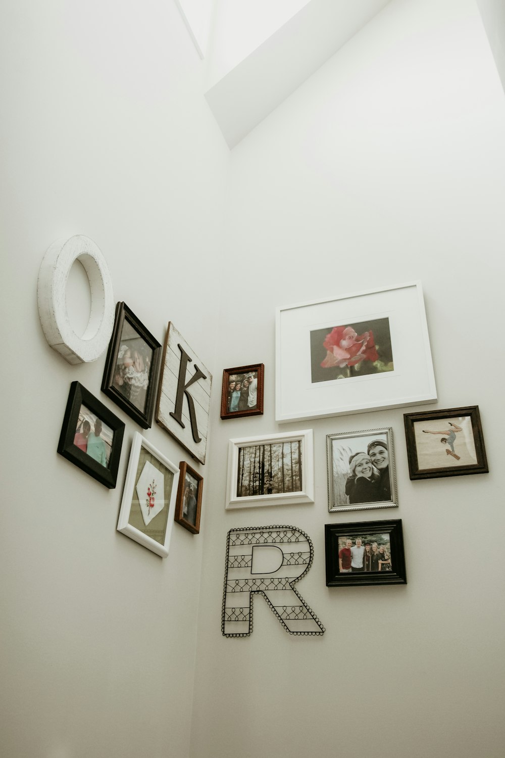 white and black photo frames hanging on wall