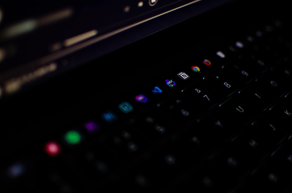 a close up of a computer keyboard in the dark