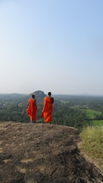 two person walking on dirt road