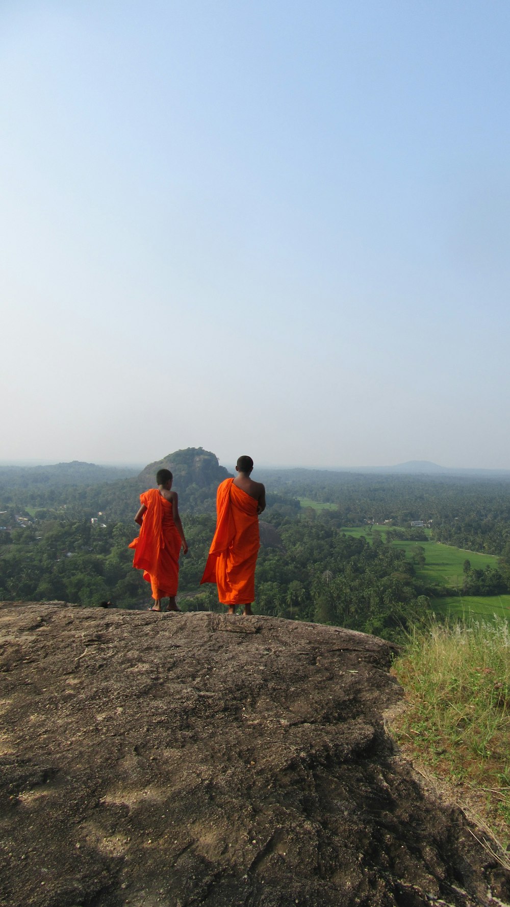 two person walking on dirt road