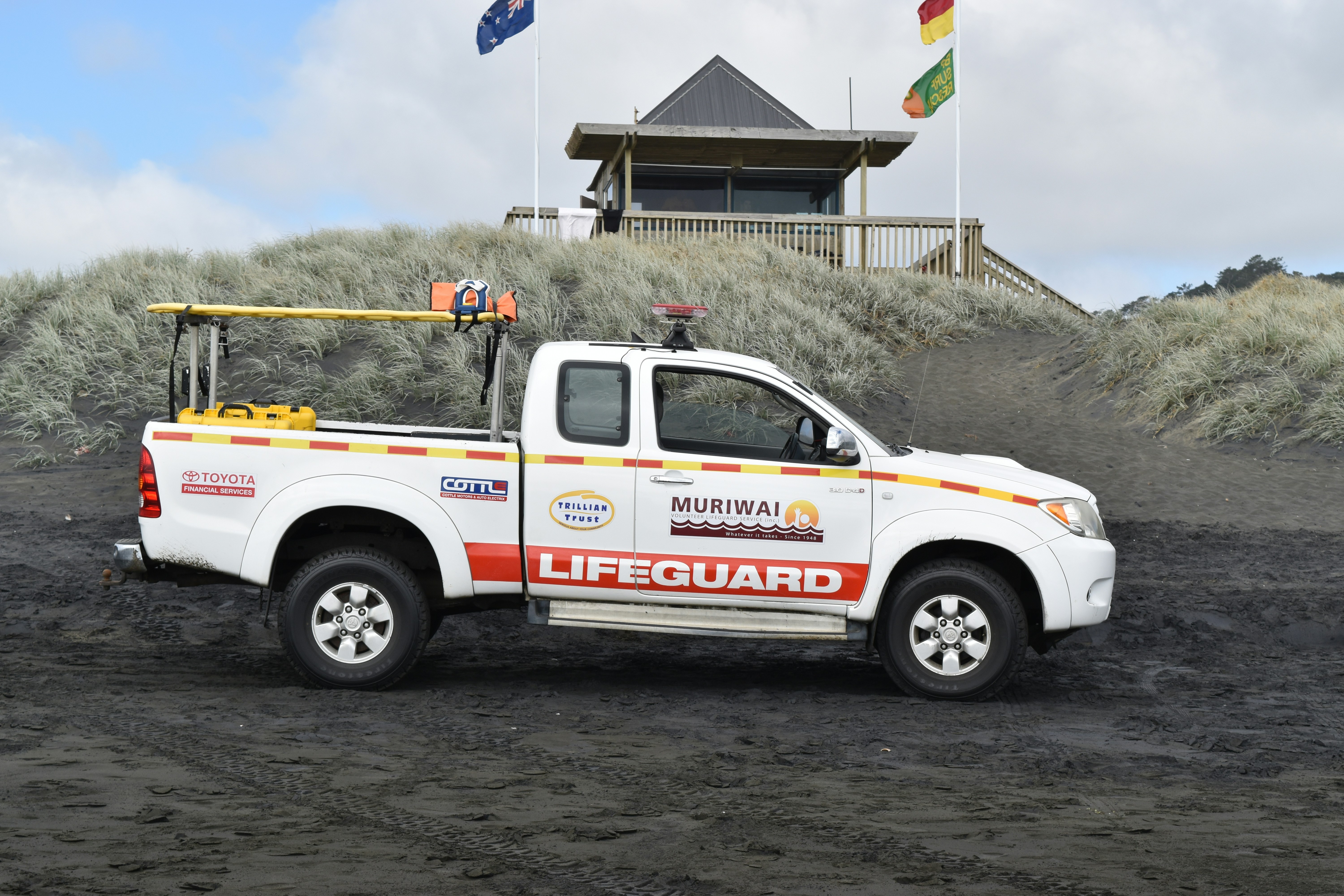 white pickup truck parked on sand