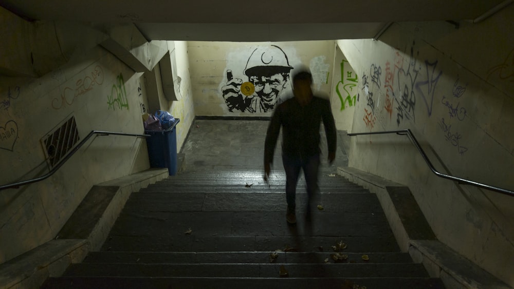person standing on tunnel surrounded by concrete wall