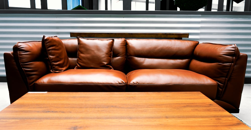 brown leather two-seat sofa