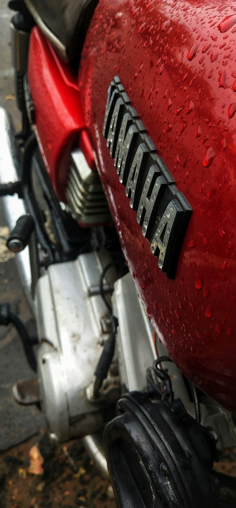 a red motorcycle parked on the side of a road