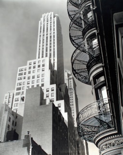 Black-and-white photo showing an urban scene with dramatic light and shadows.