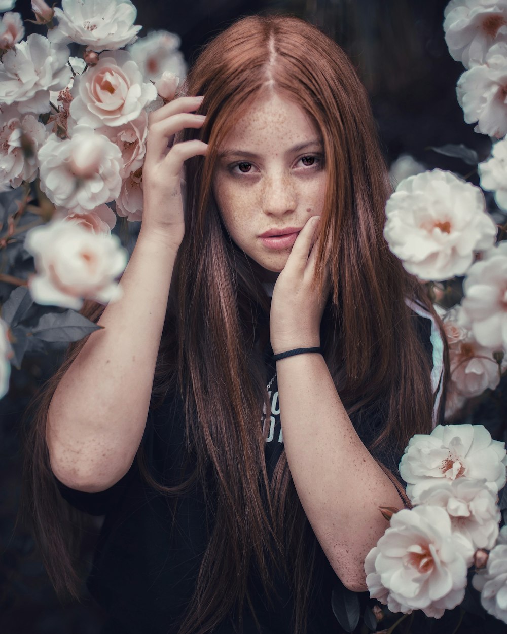 women's black and white shirt beside white petaled flowers