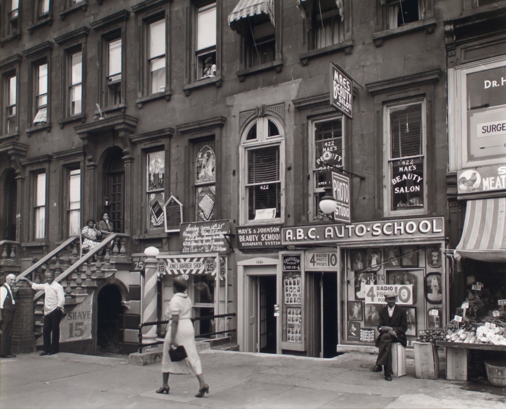 gray scale photo of people and building