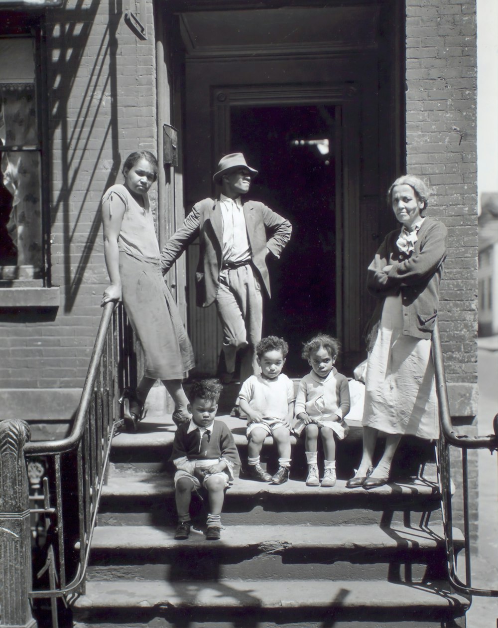 grayscale photography of people standing on stairs