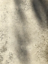 A beautifully stamped concrete patio with a subtle stone pattern and warm tones.