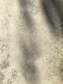 A beautifully stamped concrete patio with a subtle stone pattern and warm tones.