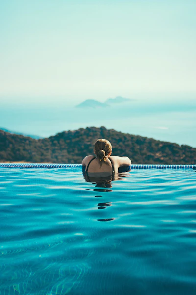 Woman relaxing in an infinity pool
