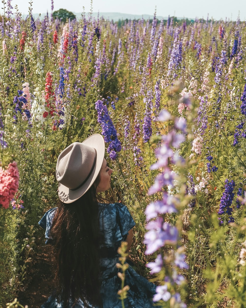 woman standing beside plants