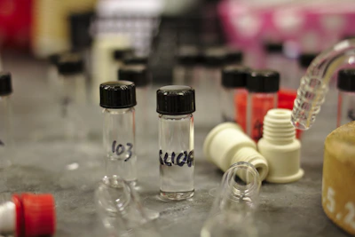 Close-up of a variety of peptide vials neatly arranged on a wooden table, highlighting their sleek labels.
