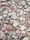 A collection of smooth, rounded stones in various shades of red, green, and gray. These stones vary in size and are packed closely together, showcasing a natural and earthy texture.
