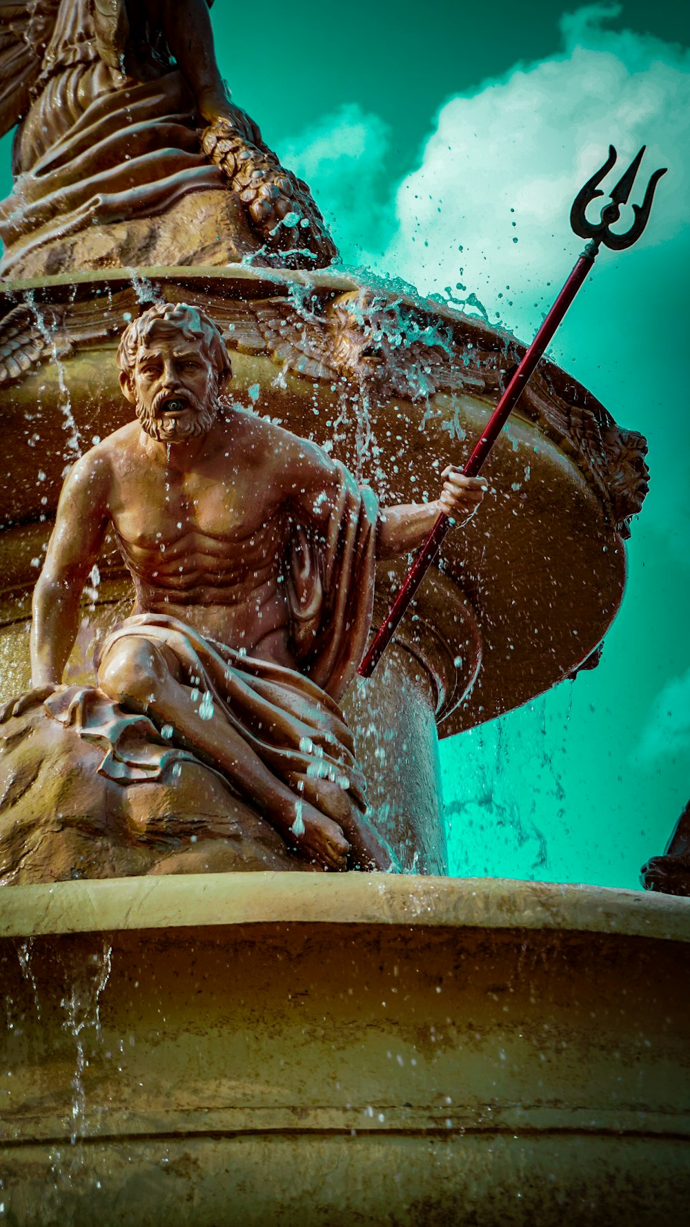 man with trident statue water fountain