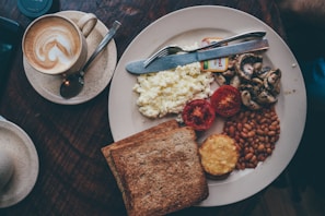 food lot in a white plate near a knife and fork close-up photography