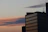 Elegant exterior view of a high-rise serviced apartment building at sunset.