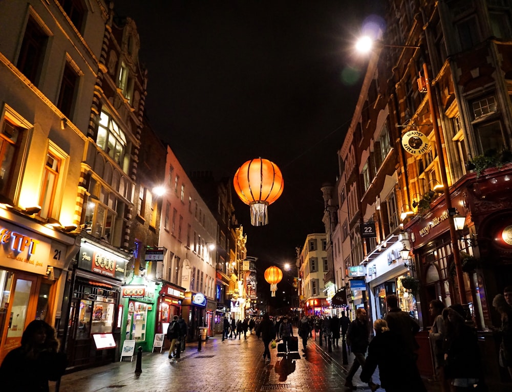 people waling on street at night