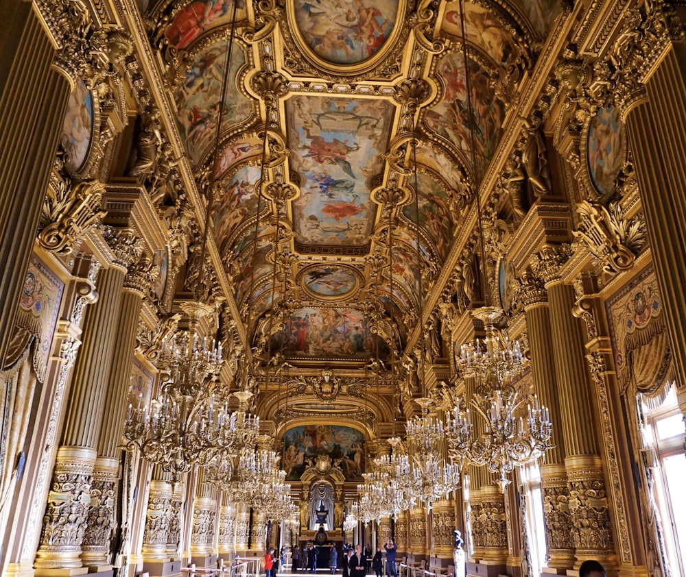 gold hallway with chandeliers