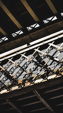 a close up of a train bridge with a train going over it