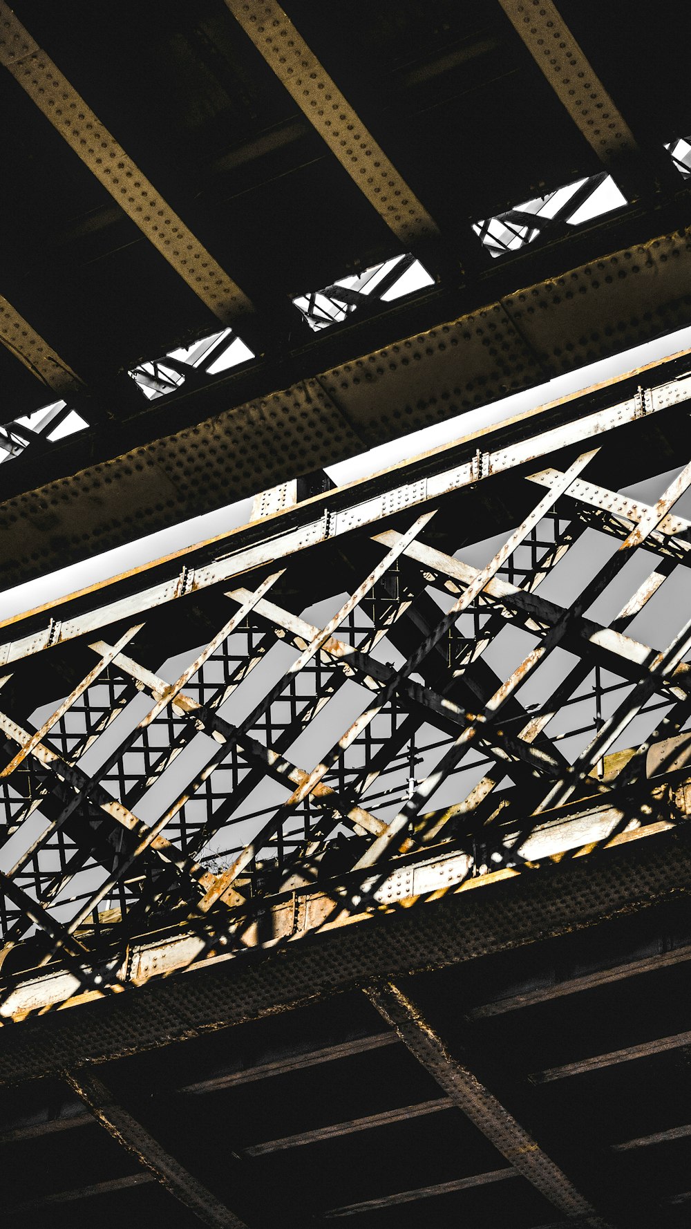 a close up of a train bridge with a train going over it