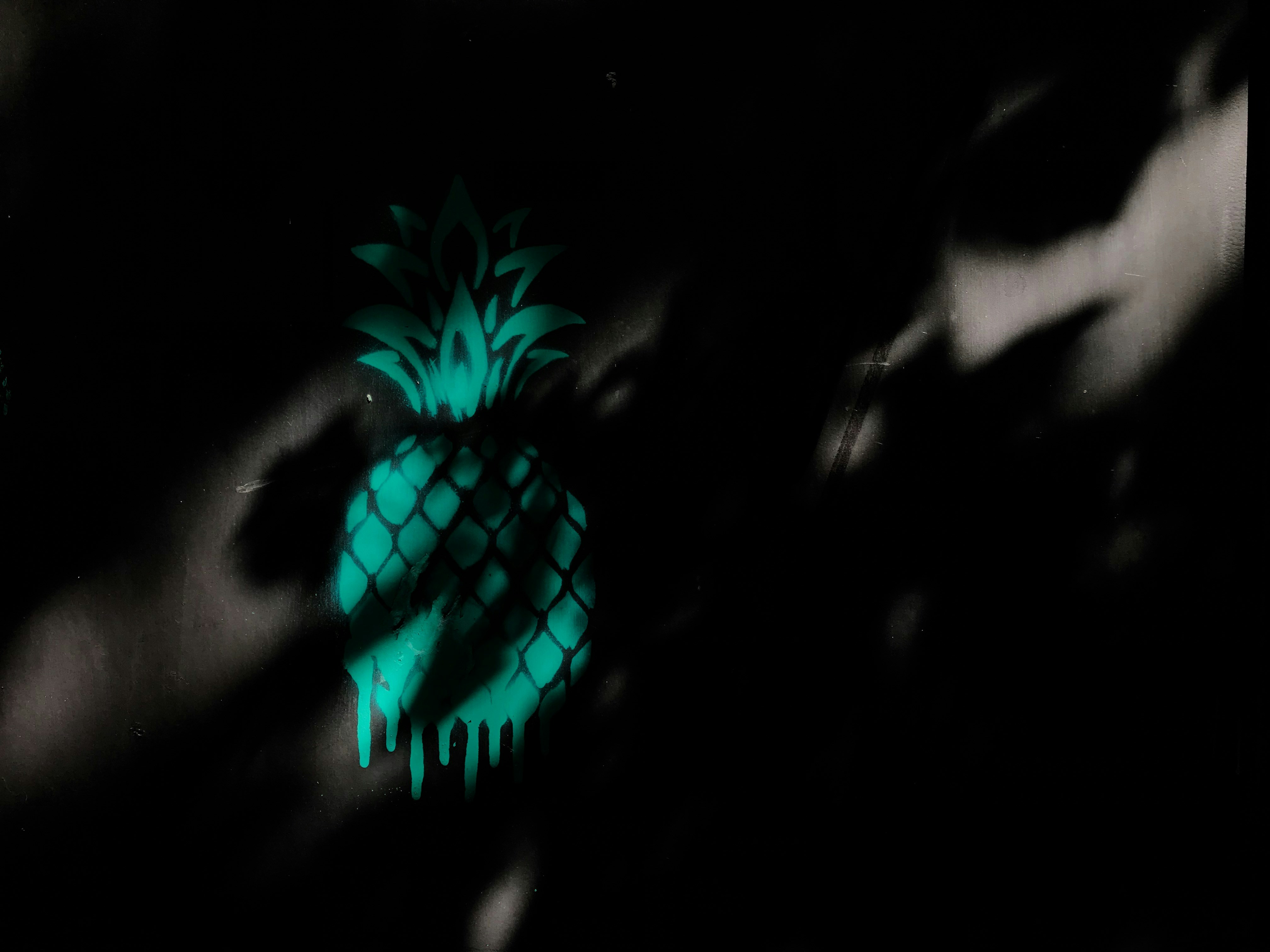 Neon pineapple glowing in dark